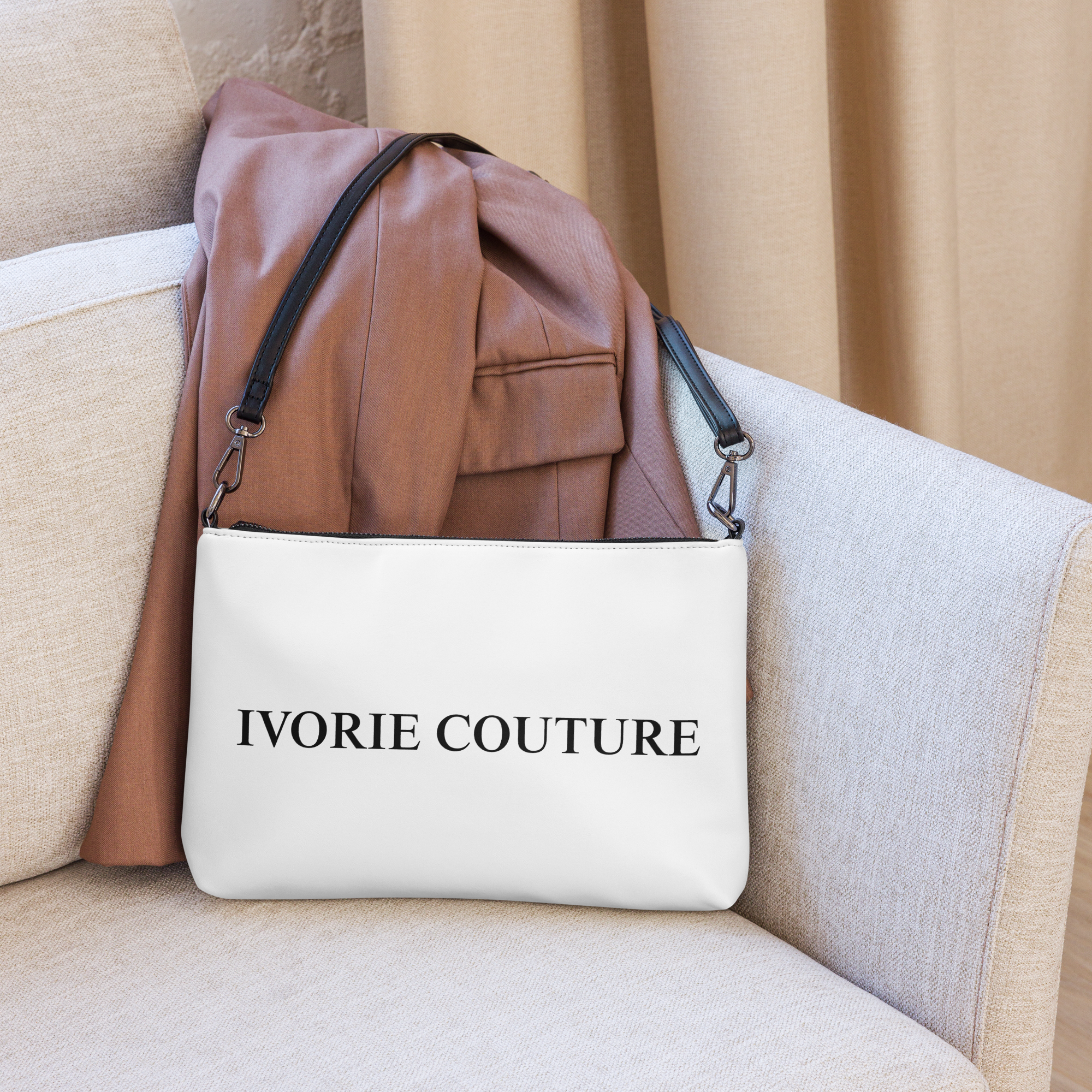 Ivorie Couture Blanca Crossbody bag purse White on couch with clothing article